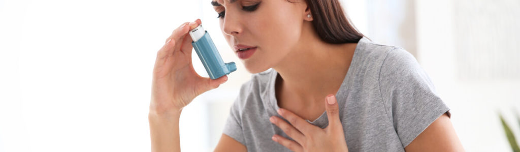 woman with inhaler because she has asthma